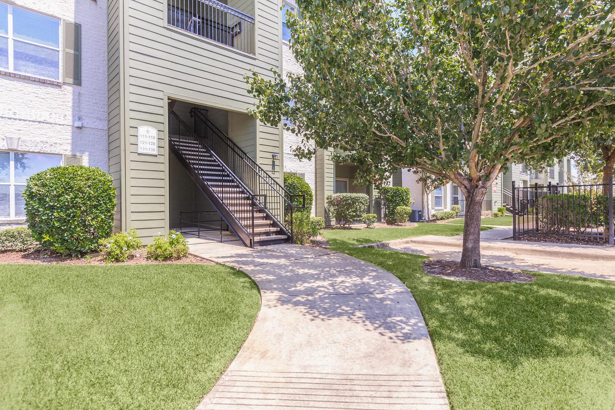 Exterior view of residential building with garage at The Avenue apartments 