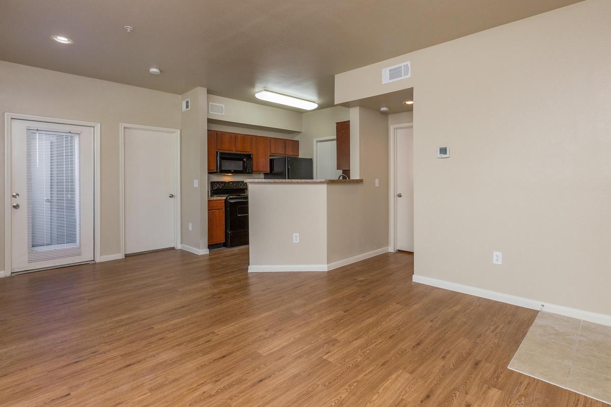 a large empty room with a wood floor
