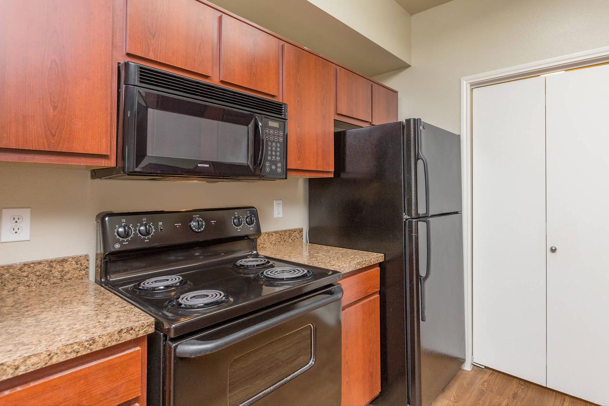 a stove top oven sitting inside of a kitchen