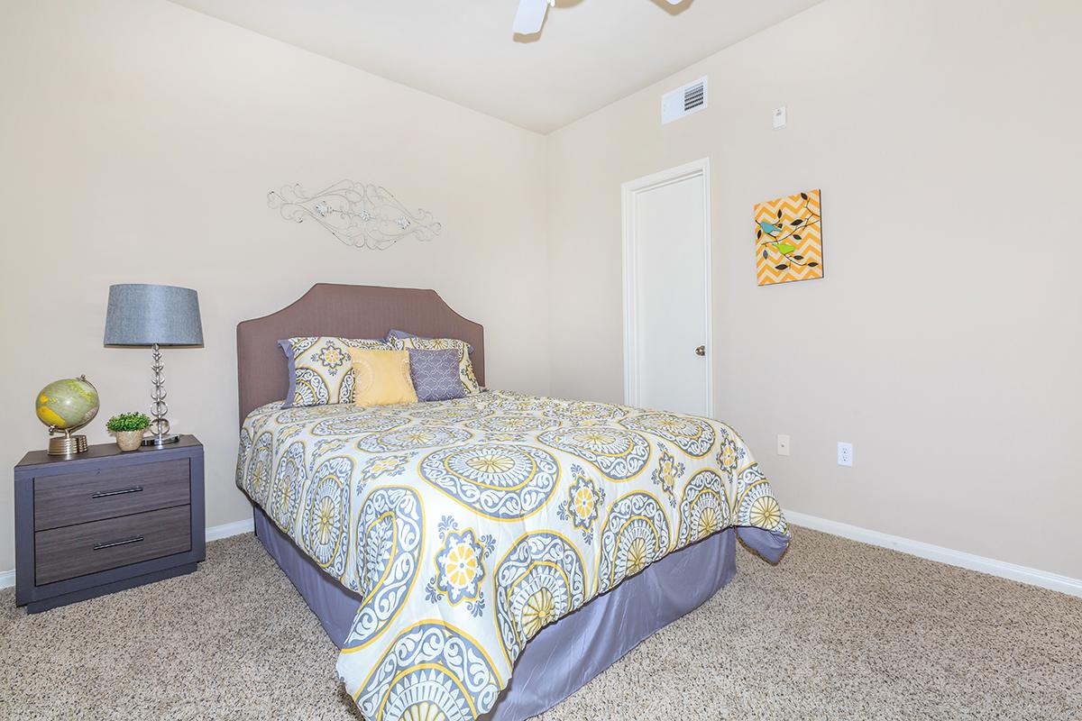 a bedroom with a bed and desk in a small room