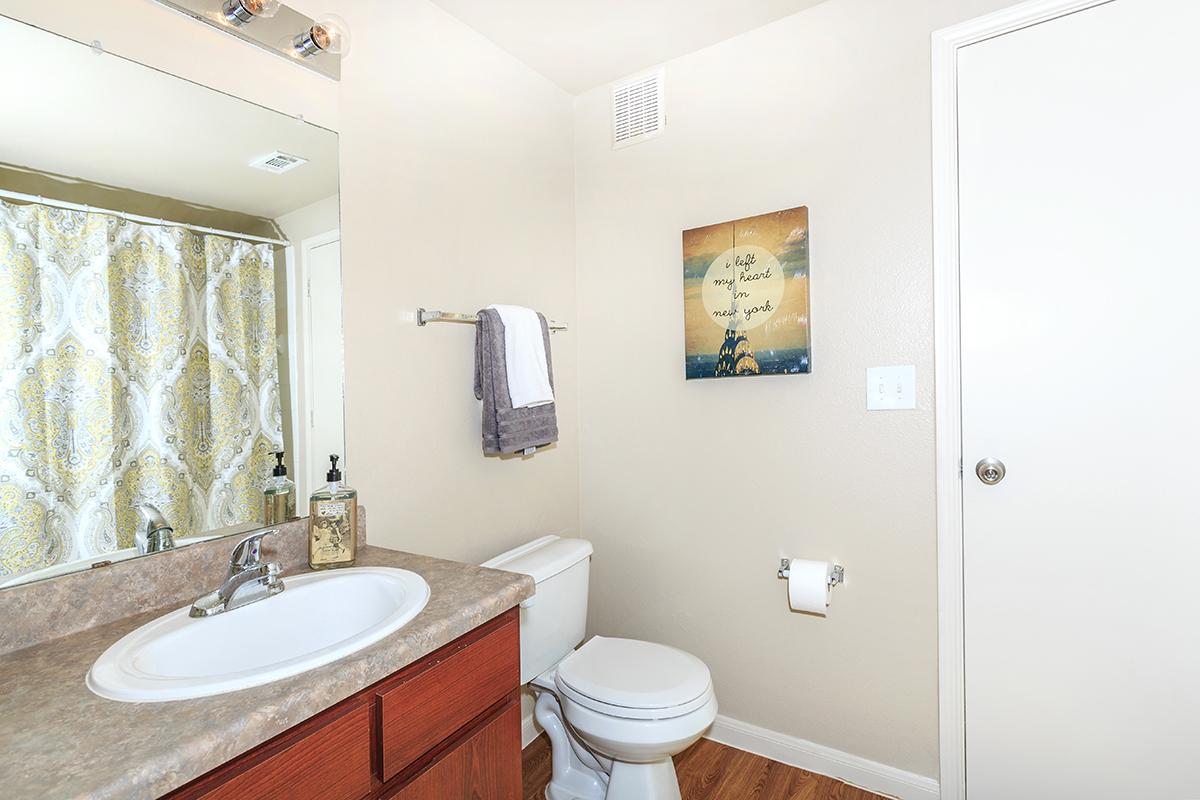 Bathroom with sink, toilet, and towel rack 