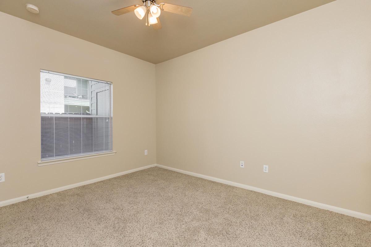 Bedroom with carpeted floors and ceiling fan 