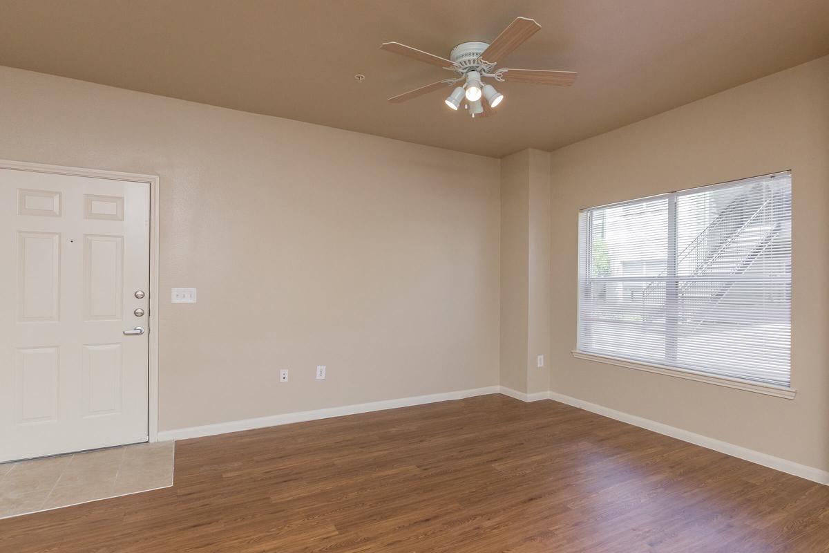 Large apartment living room with ceiling fan 
