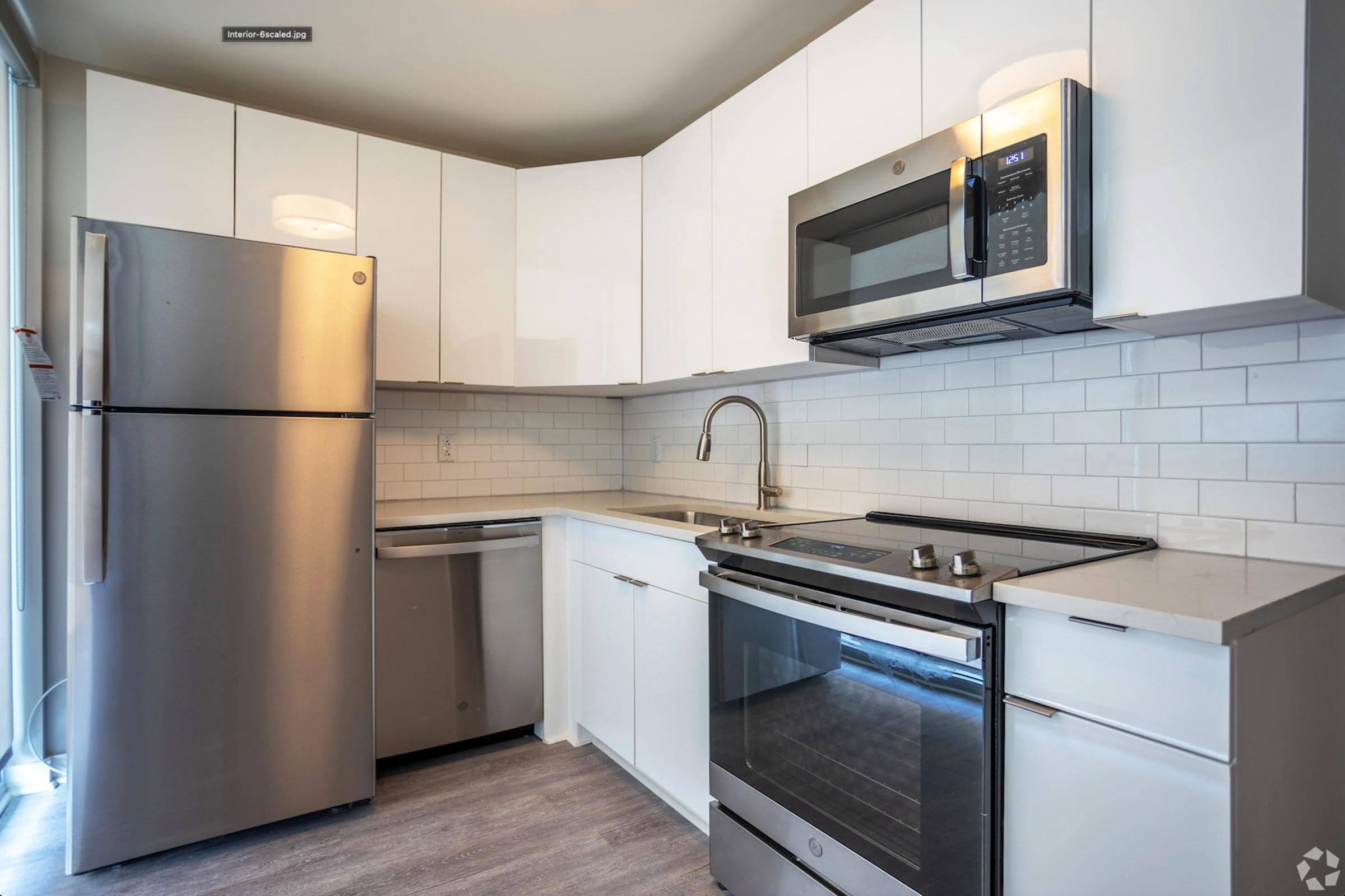 a kitchen with a stove and a refrigerator