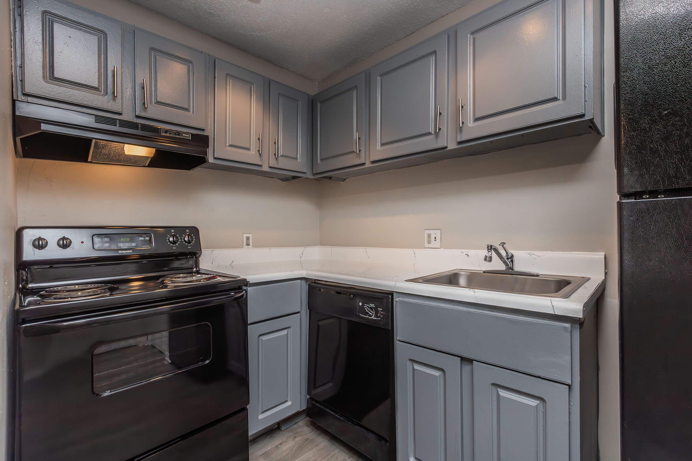 a stove top oven sitting inside of a kitchen