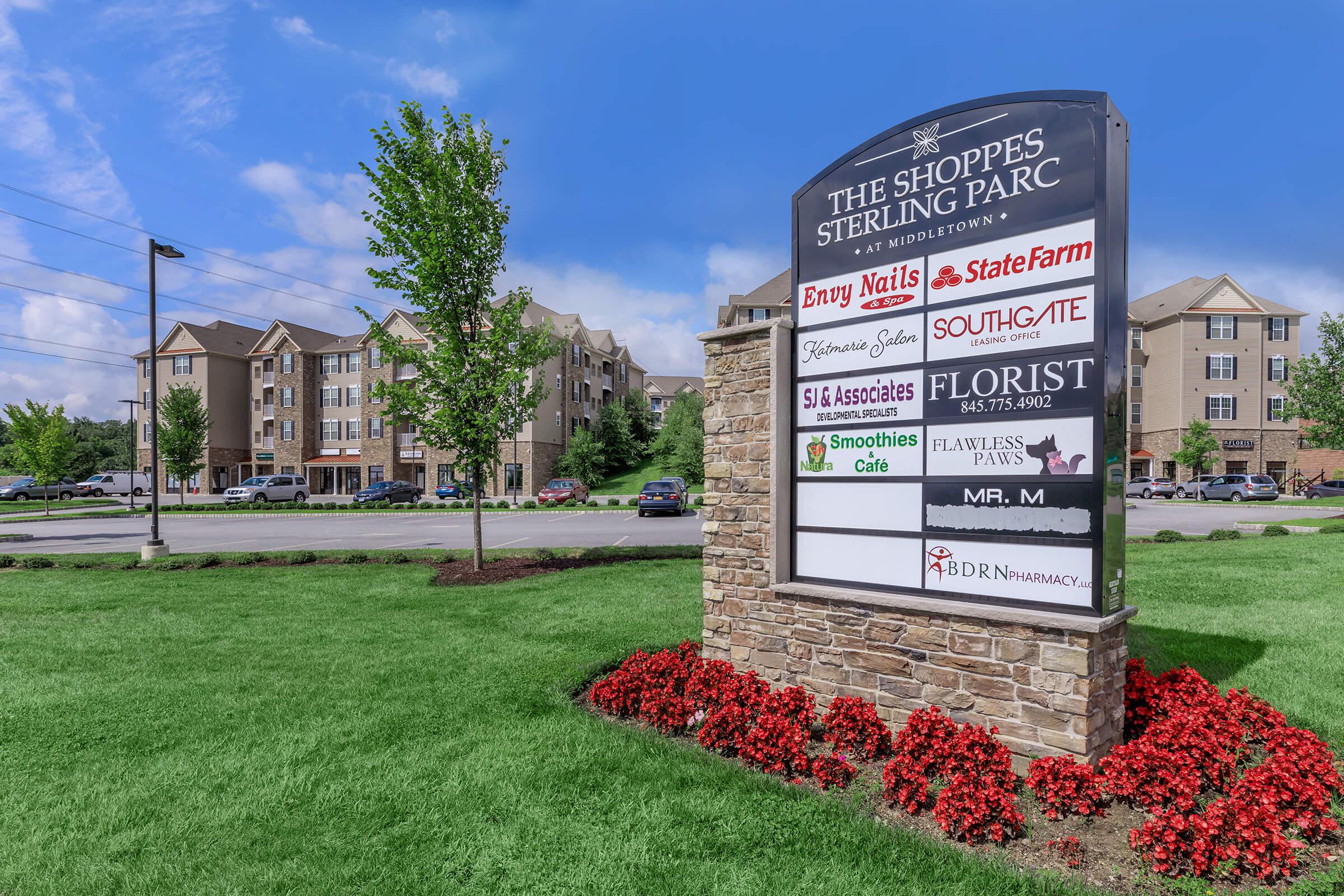 a close up of a flower garden in front of a building