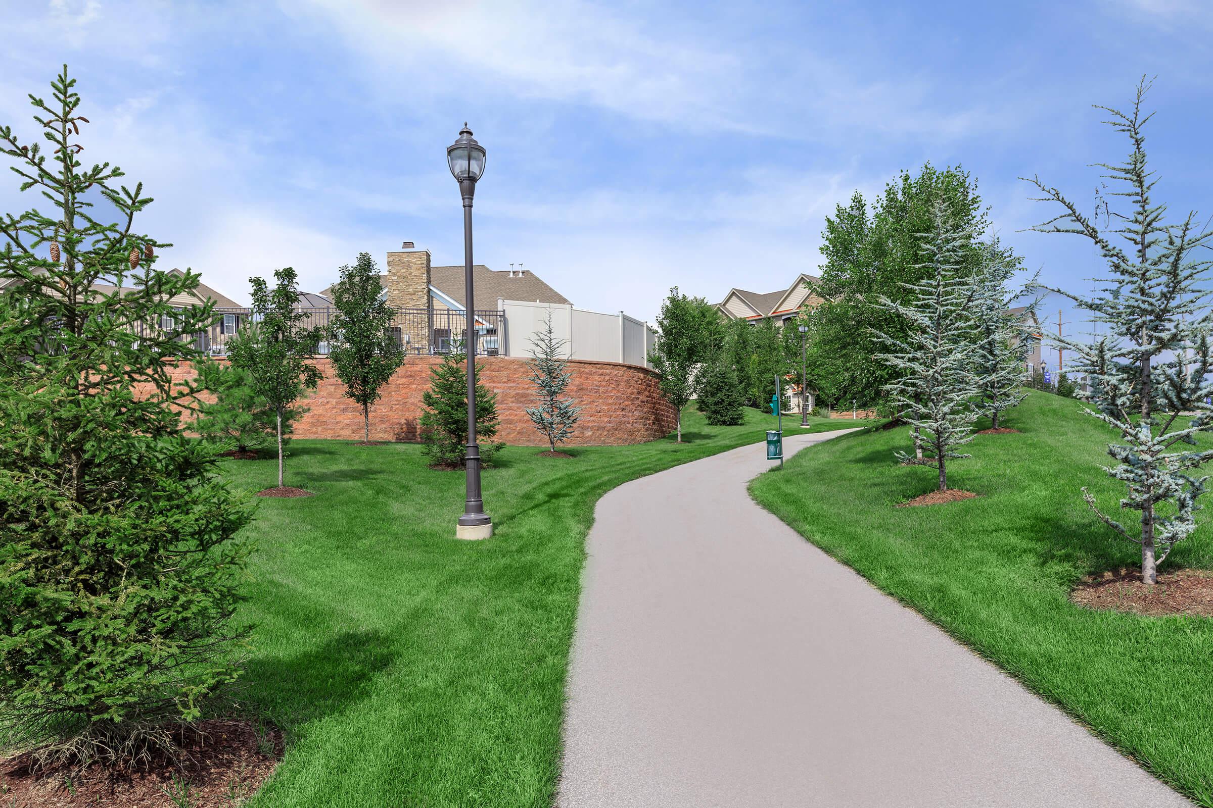 a path with trees on the side of a building