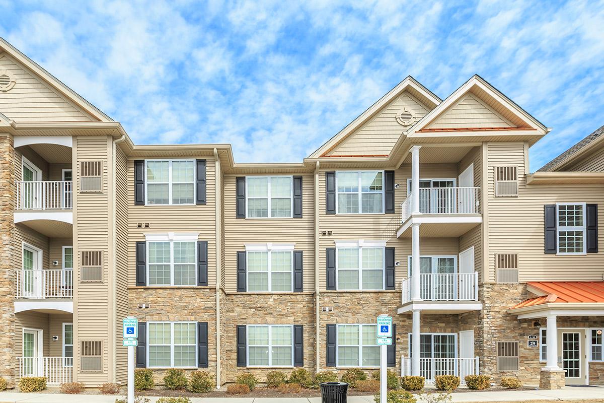 a large white building in front of a house