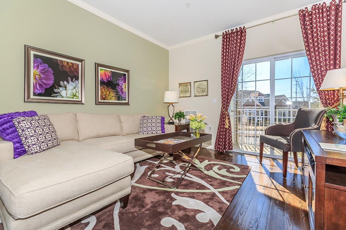 a living room filled with furniture and a large window