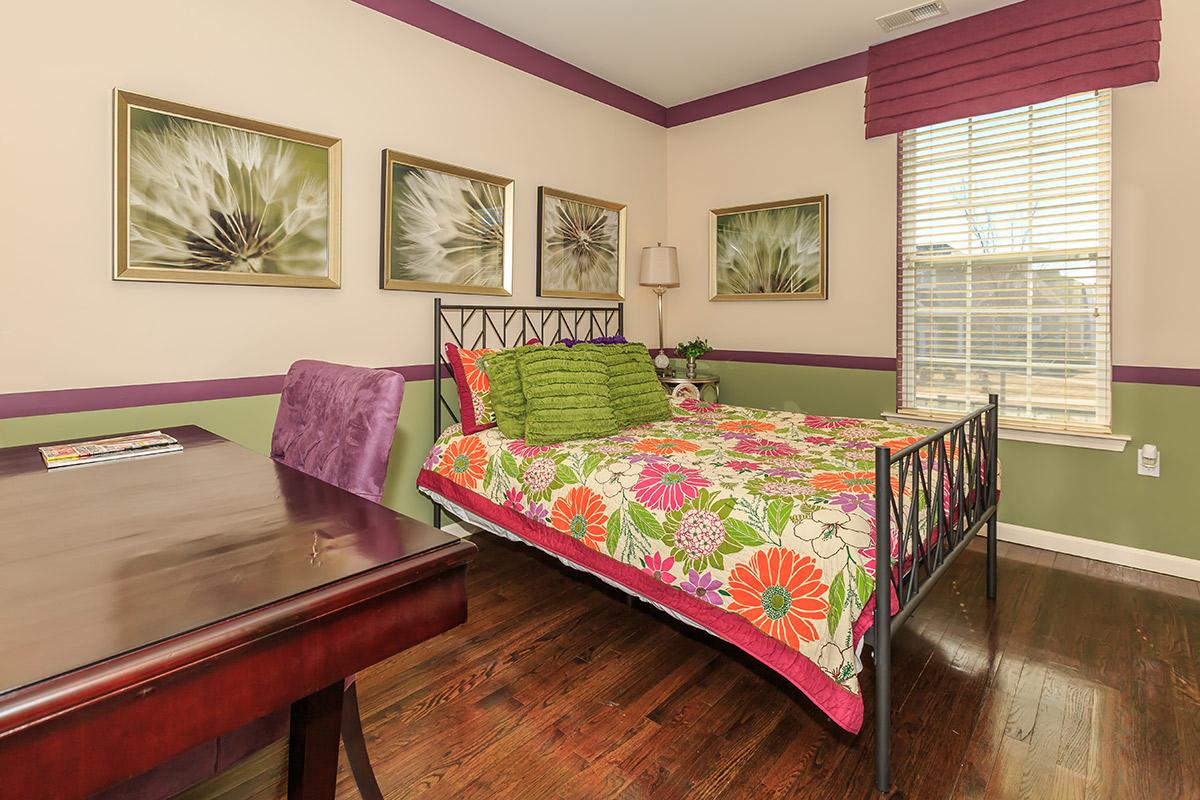 a colorful living room with a wooden floor