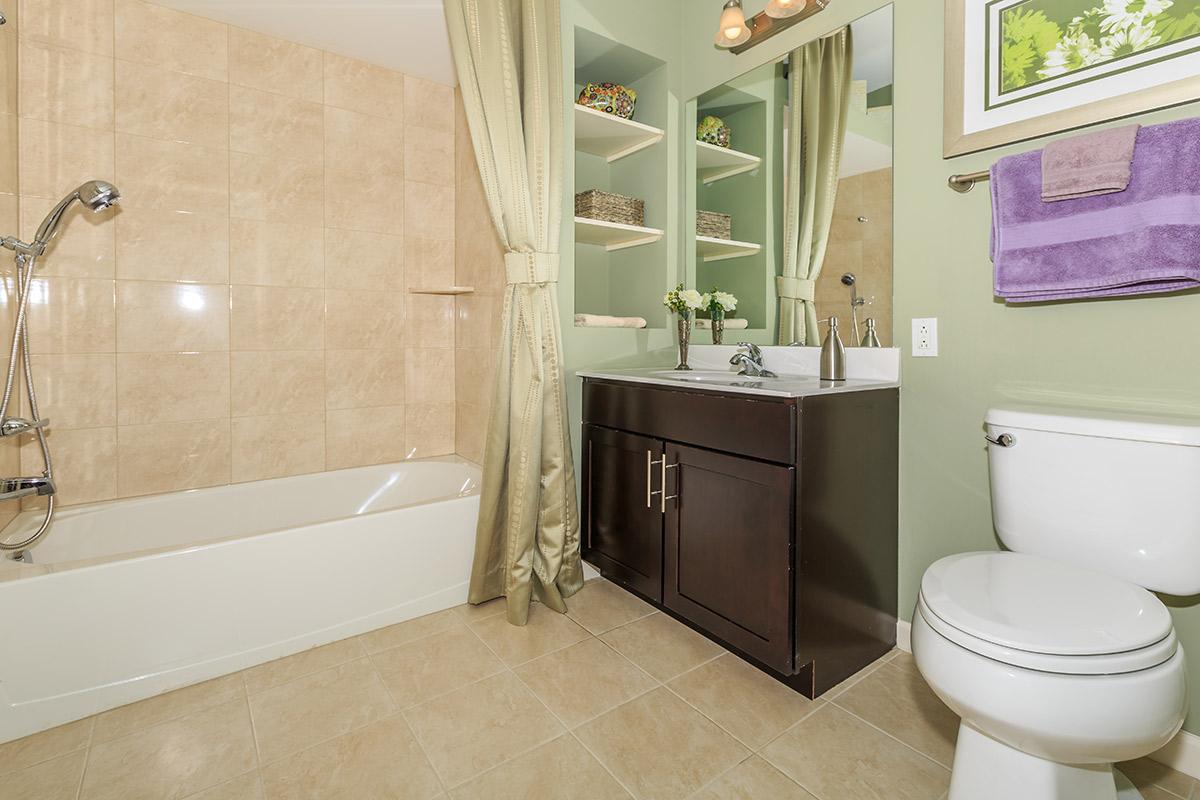 a white tub sitting next to a sink