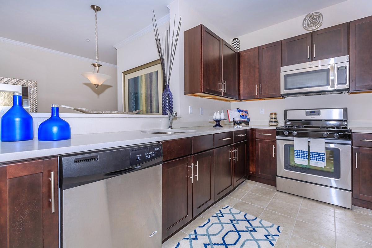 a kitchen with stainless steel appliances and wooden cabinets