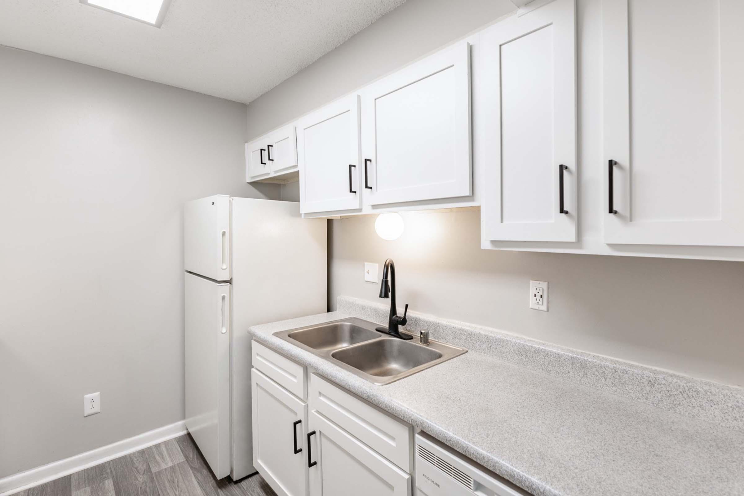 a kitchen with a sink and a mirror