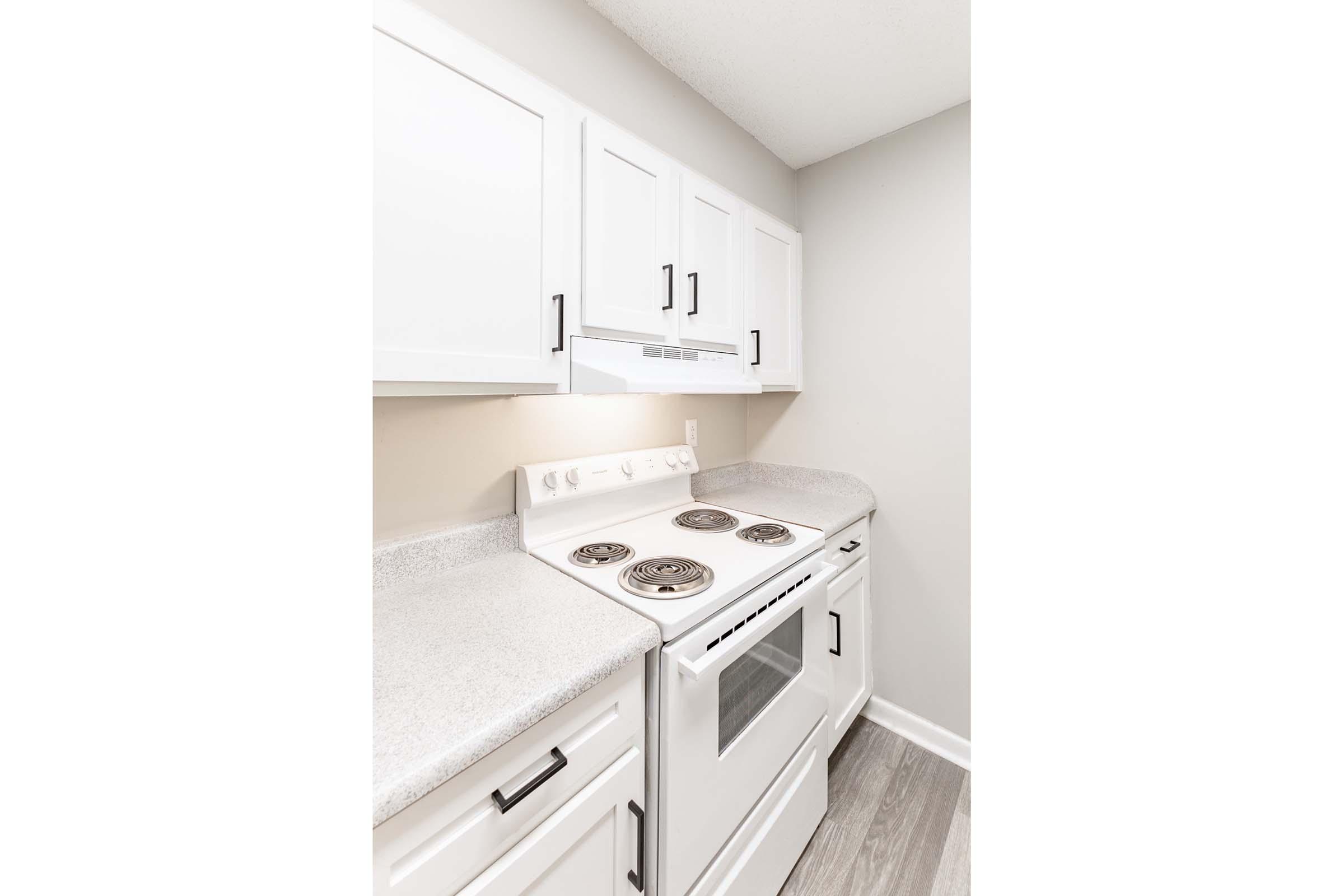 a stove top oven sitting inside of a kitchen