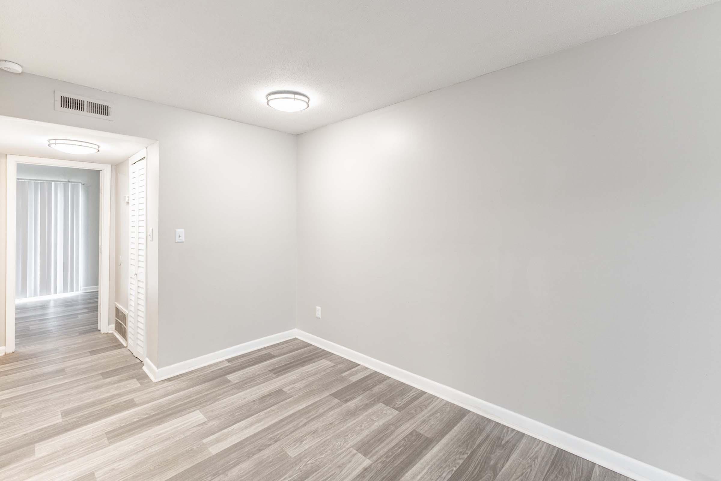 a large empty room with a wooden floor