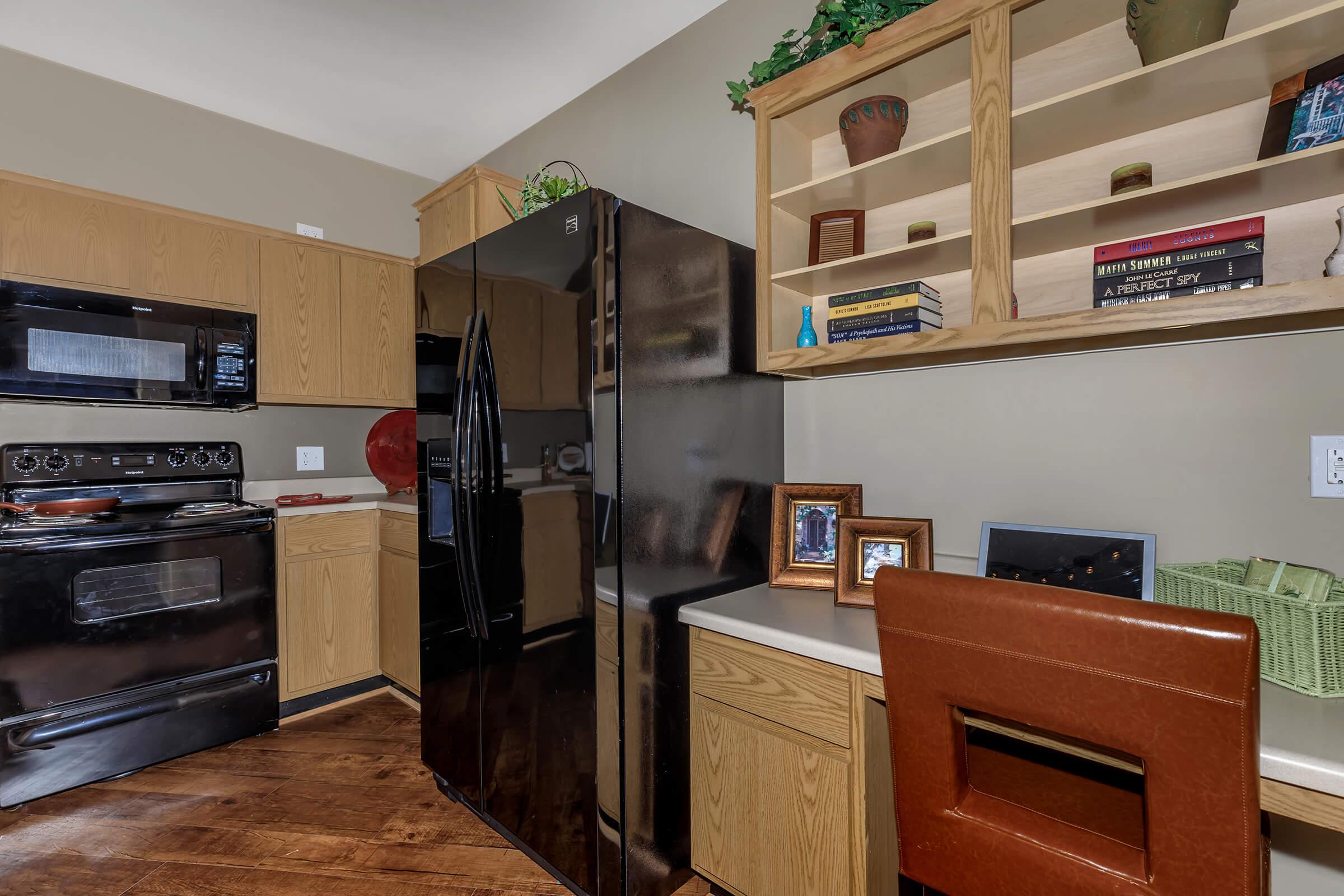 a kitchen with a stove top oven sitting inside of a room