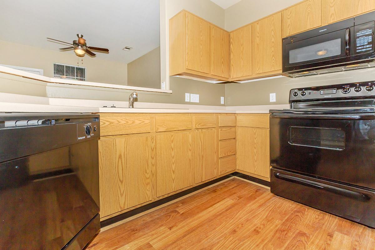 a kitchen with stainless steel appliances and wooden cabinets