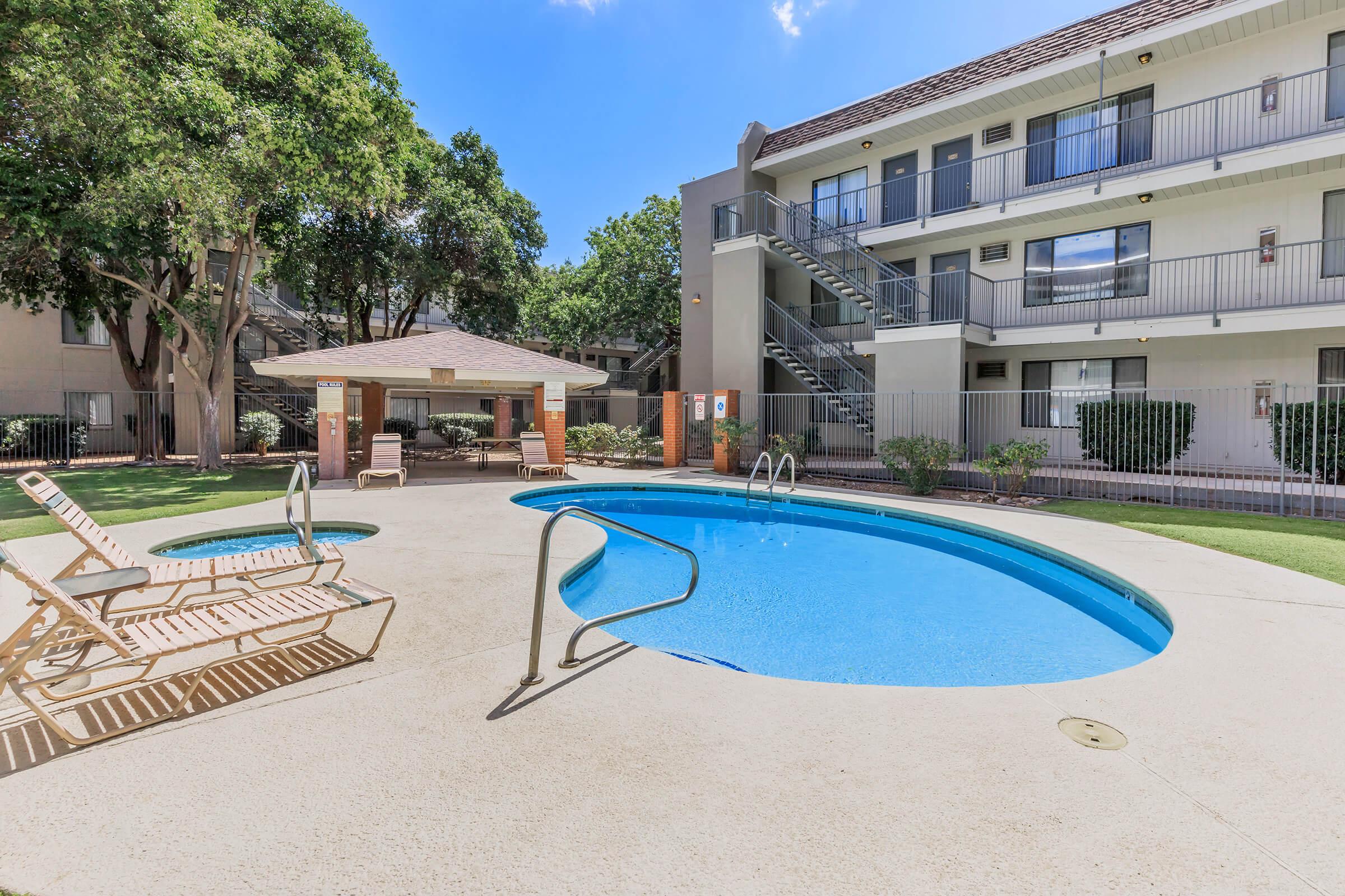 a large lawn in front of a pool