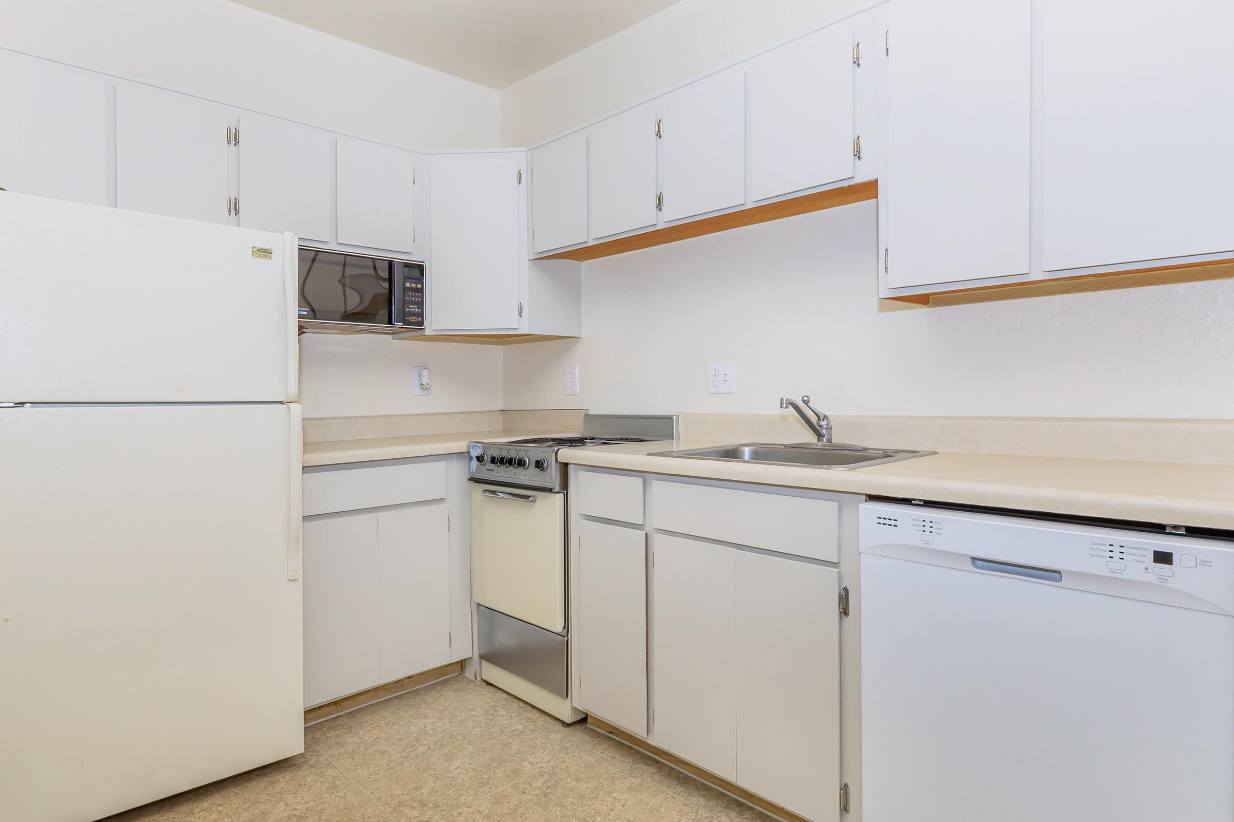 a kitchen with a stove and a refrigerator