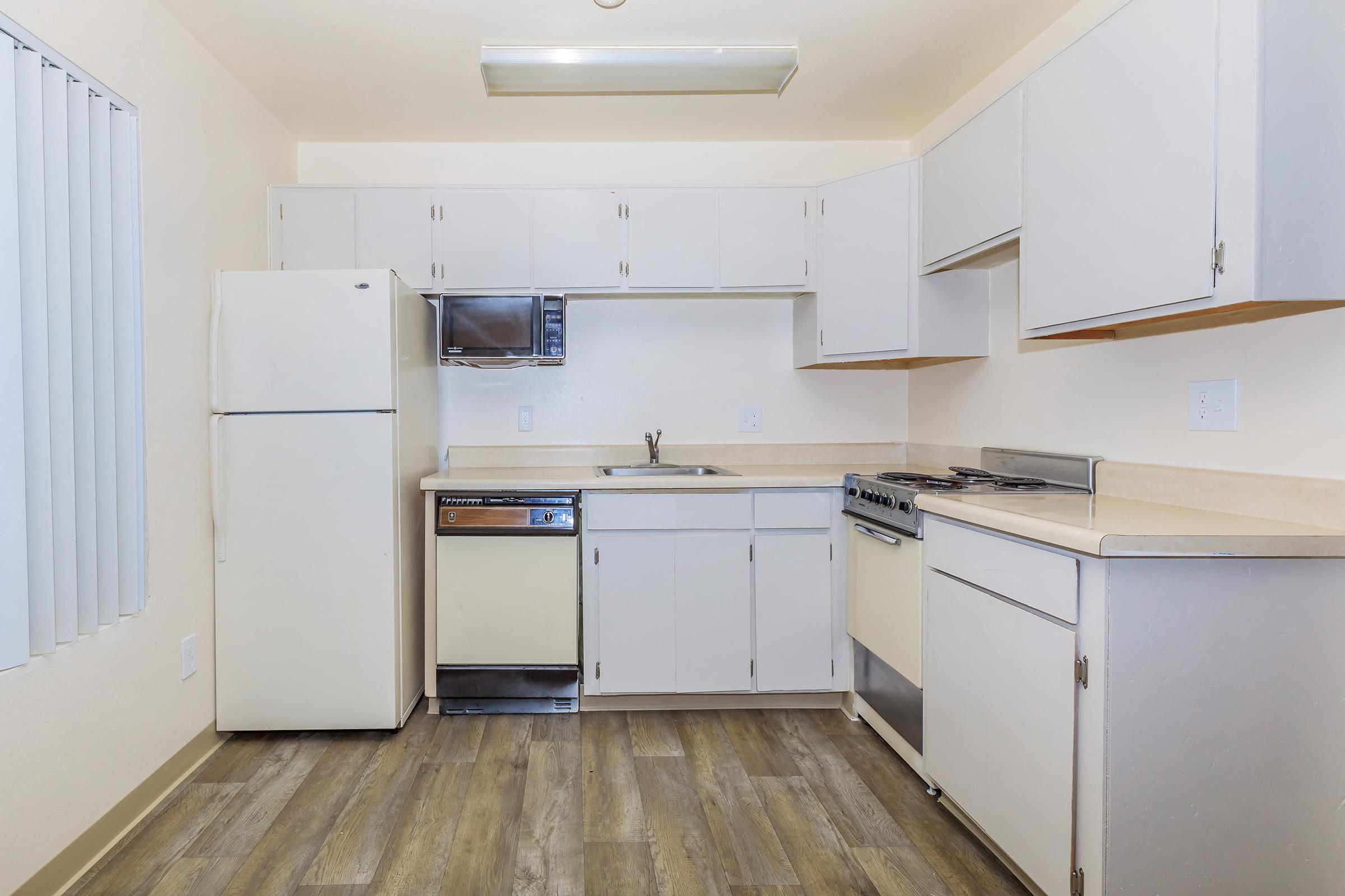 a kitchen with a stove and a refrigerator