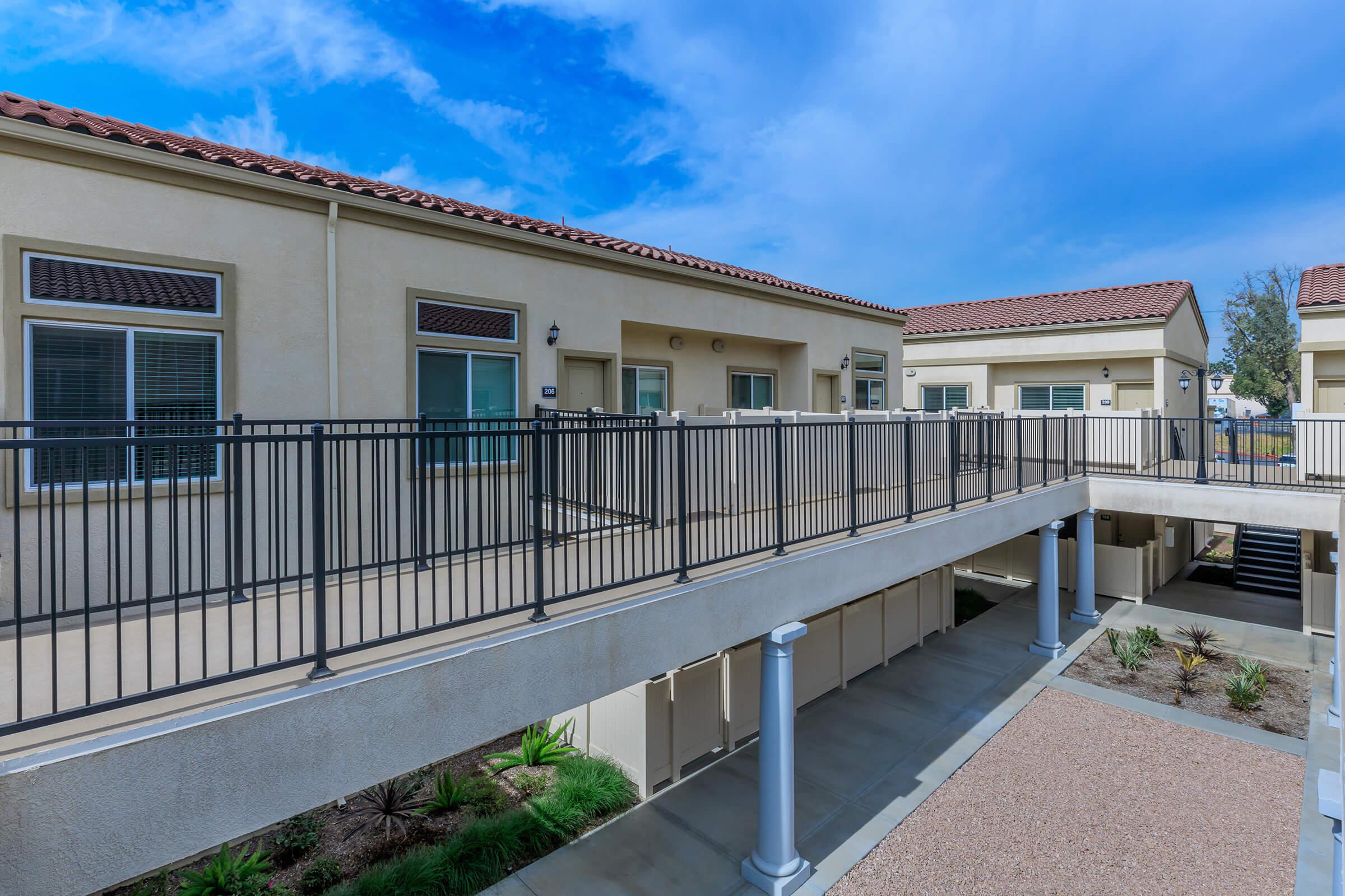 a house with a fence in front of a building