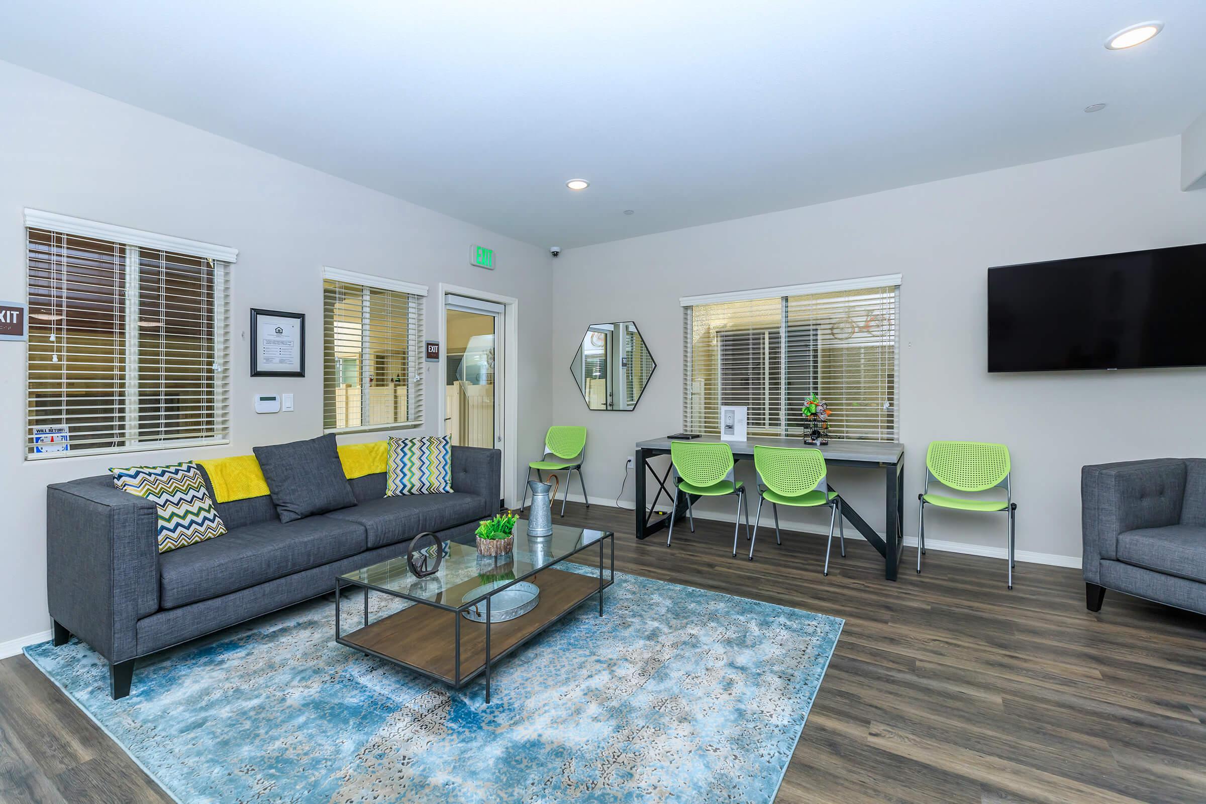 a living room filled with furniture and a flat screen tv