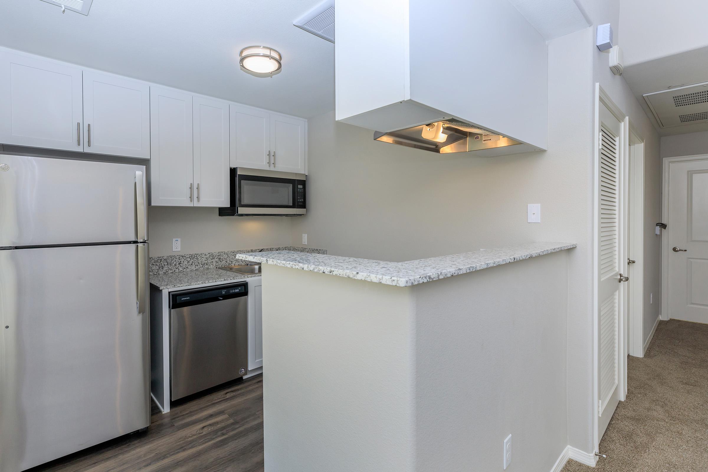 a kitchen with a sink and a refrigerator