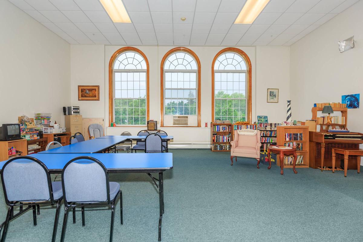 a living room filled with furniture and a large window