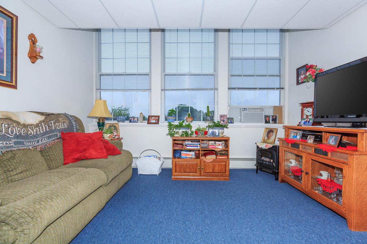 a bedroom with a bed and desk in a room