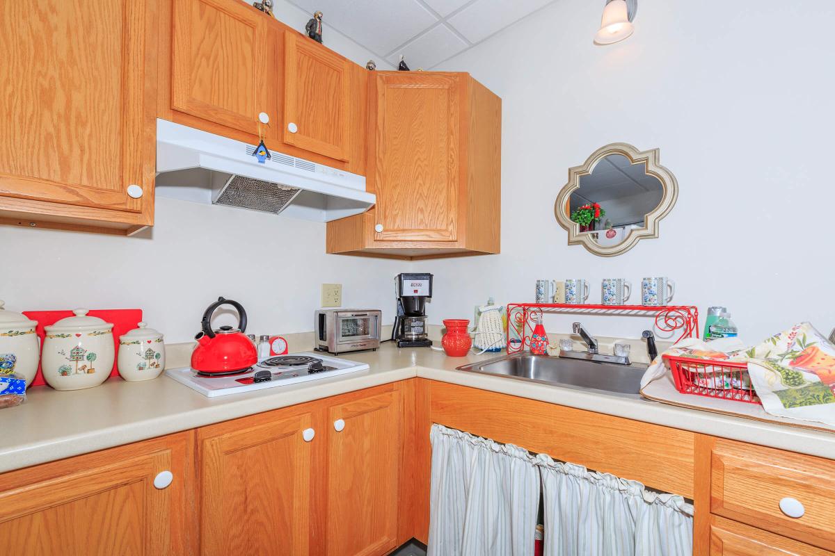 a kitchen with stainless steel appliances and wooden cabinets