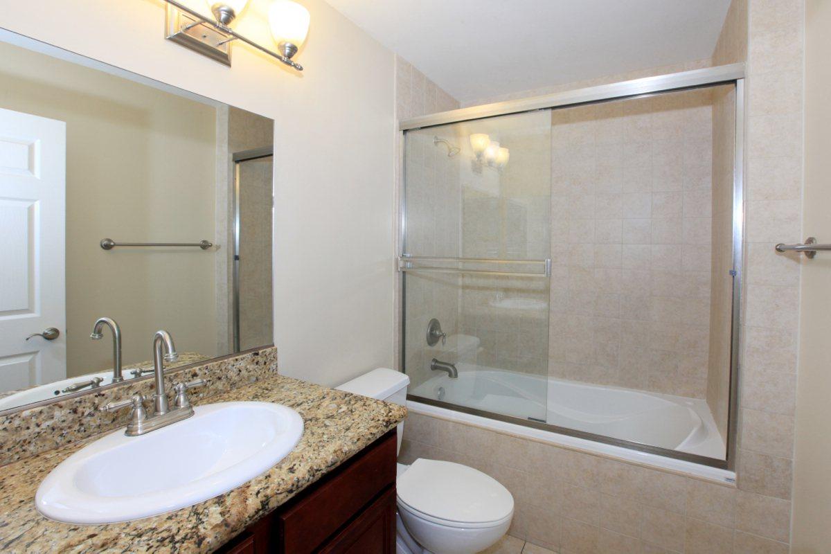 a shower that has a sink and a mirror