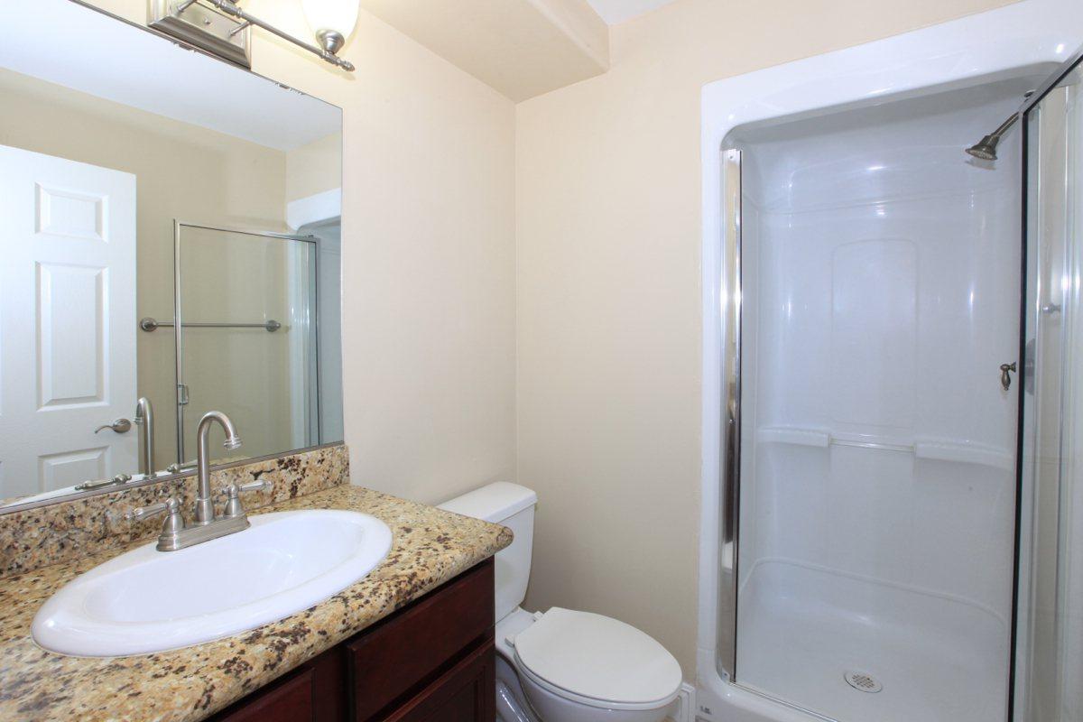 a large white tub next to a glass shower door