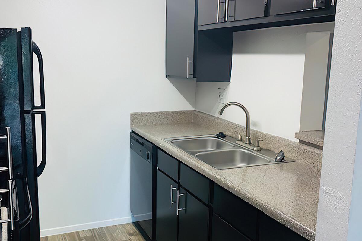 a kitchen with a sink and a mirror