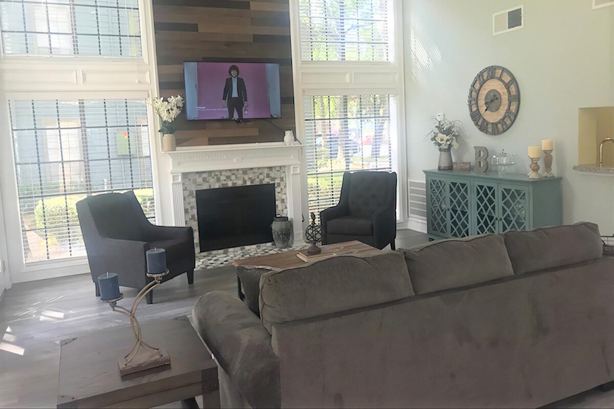 a living room filled with furniture and a large window