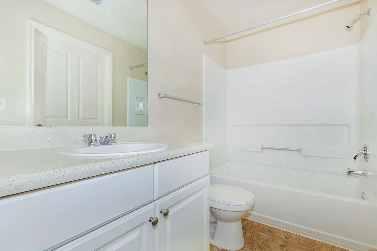 a white tub sitting next to a sink