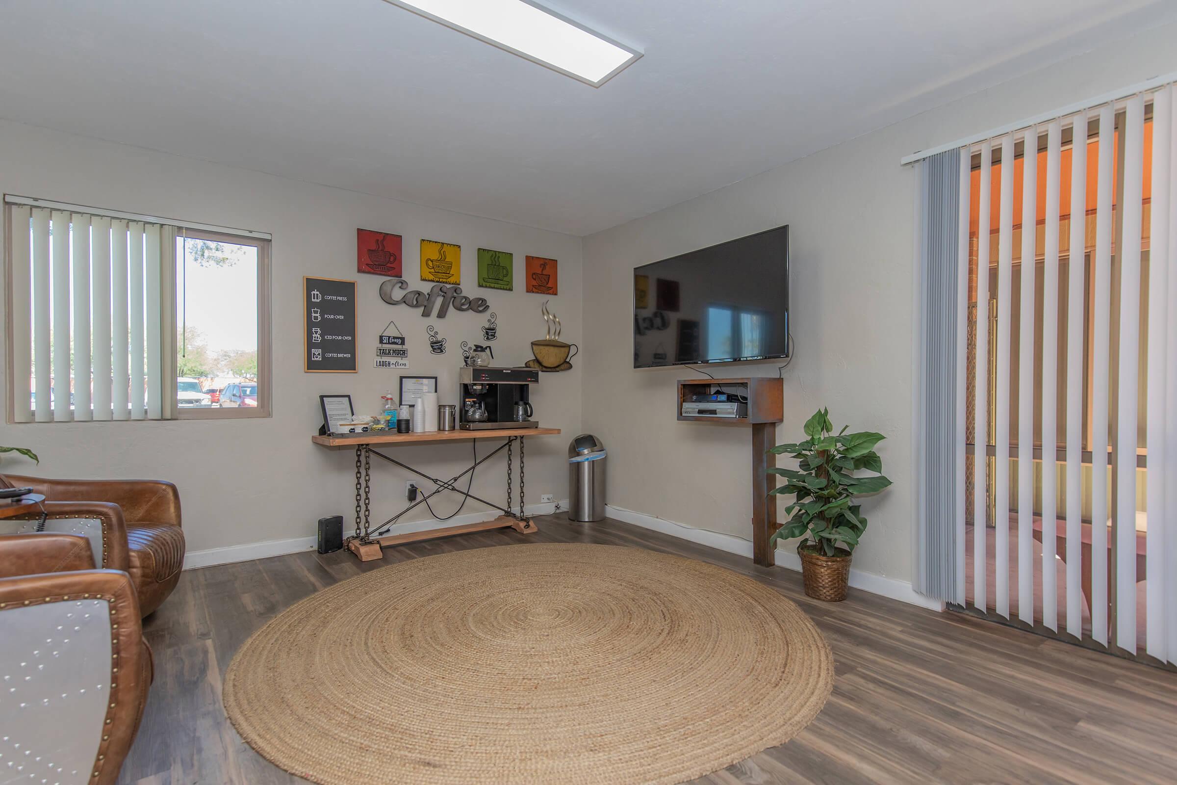 a living room filled with furniture and a flat screen tv