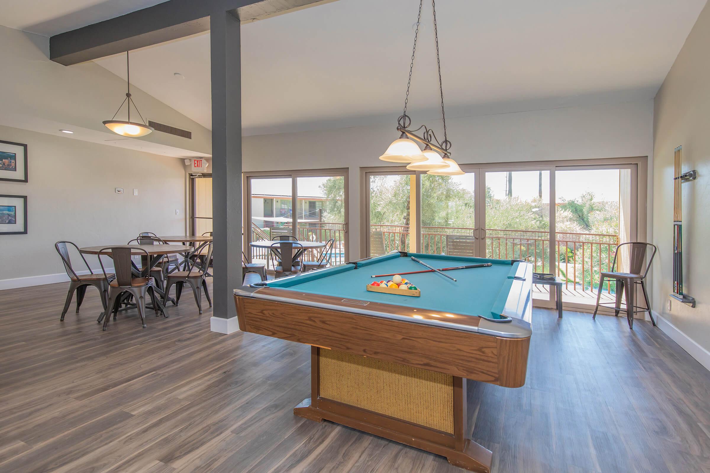 a living room filled with furniture on top of a wooden floor