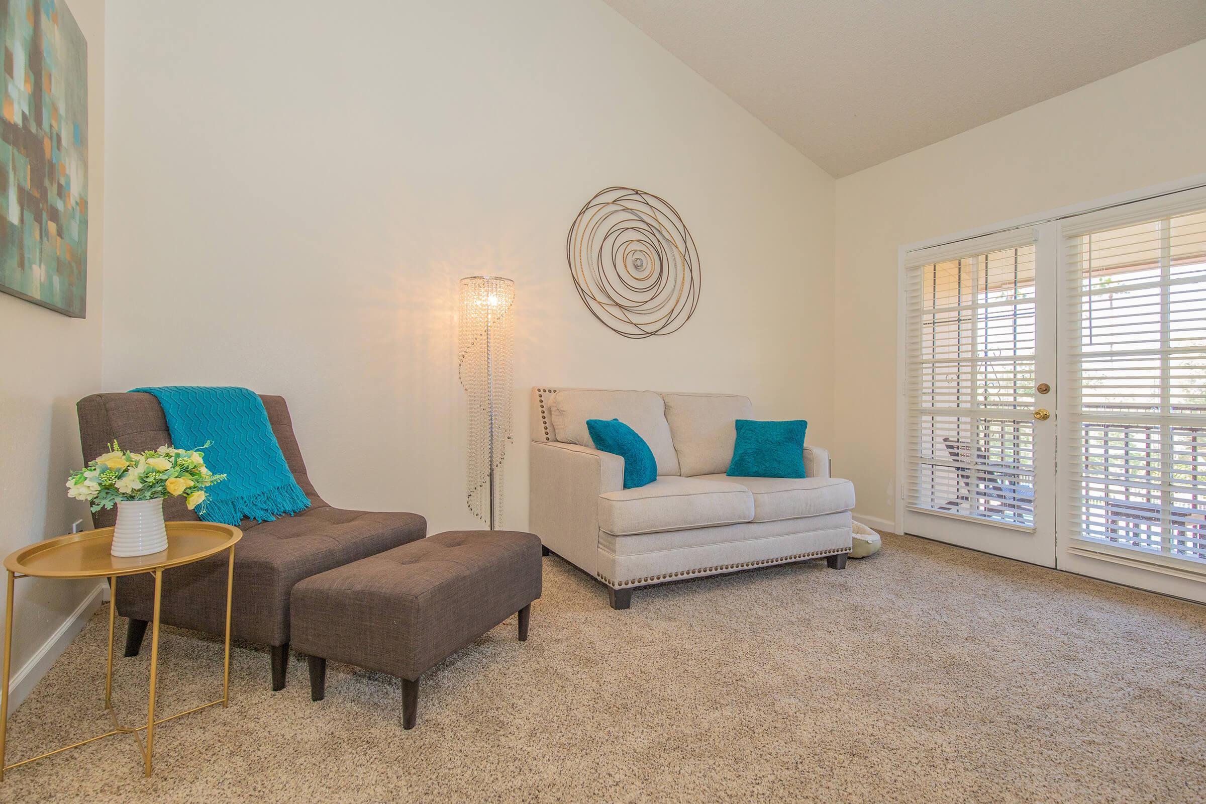 a living room filled with furniture and a large window