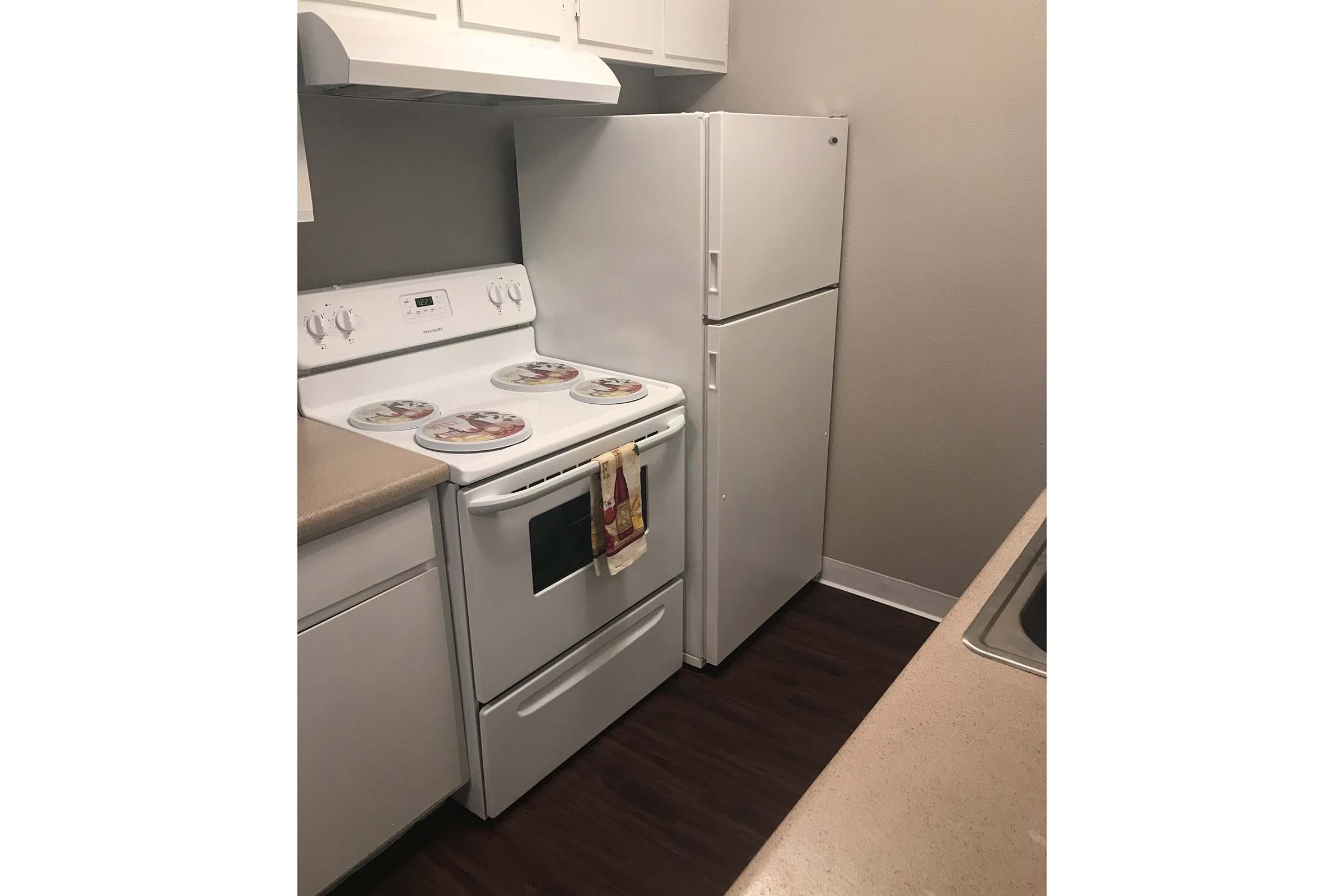 a stove top oven sitting inside of a refrigerator
