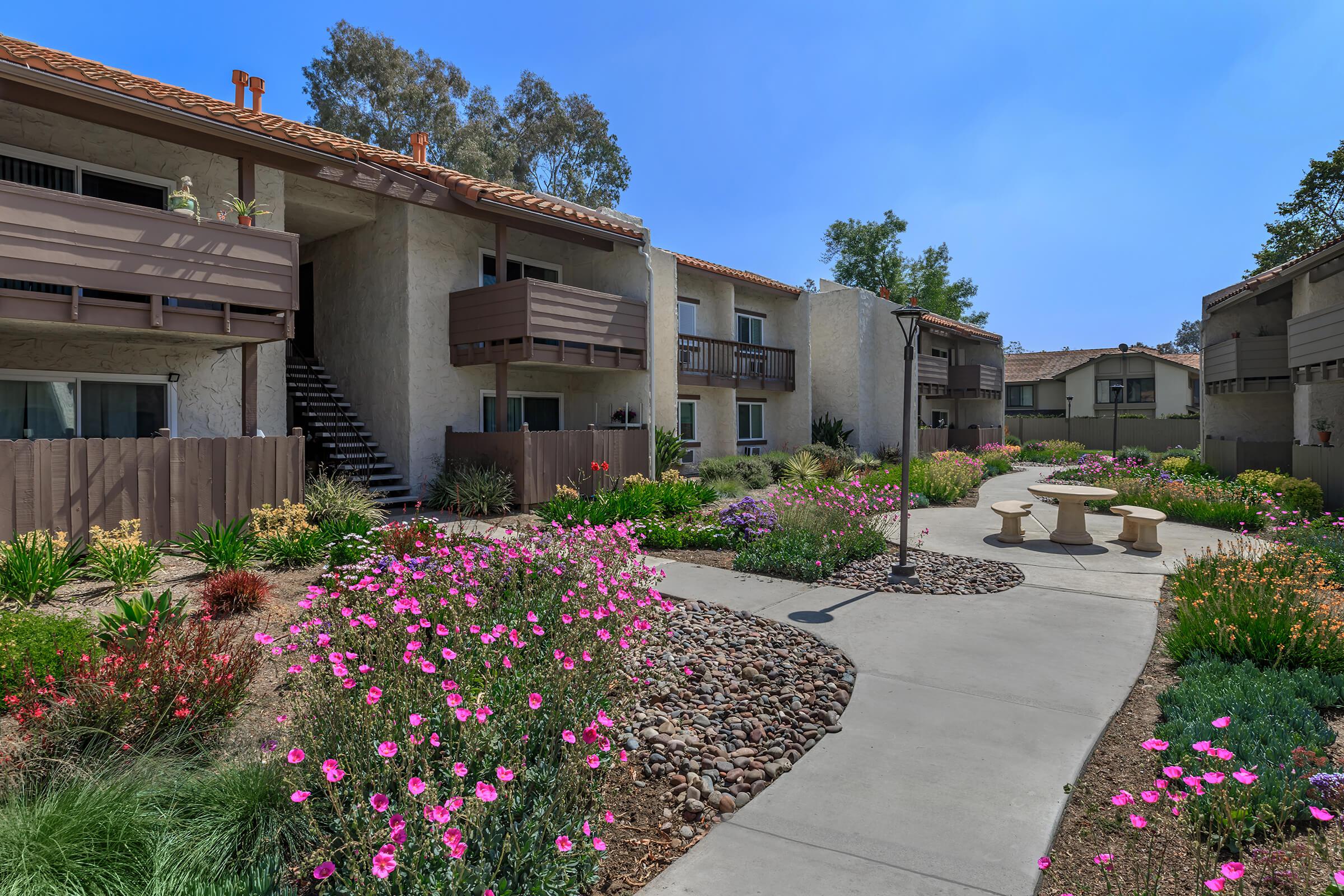 a colorful flower garden in front of a house