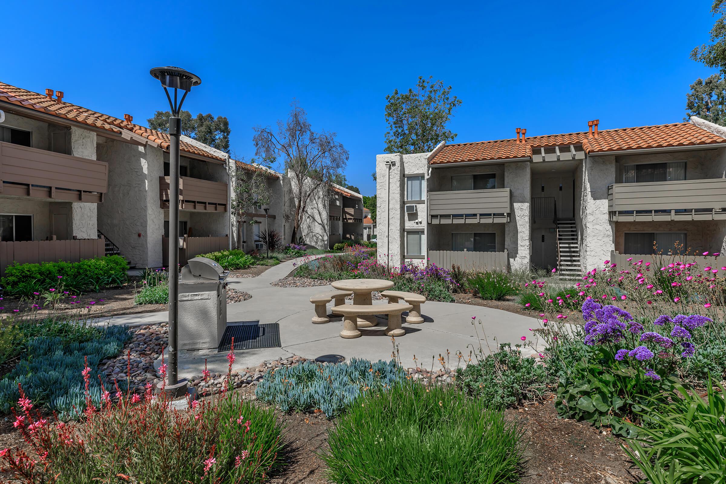 a colorful flower garden in front of a house