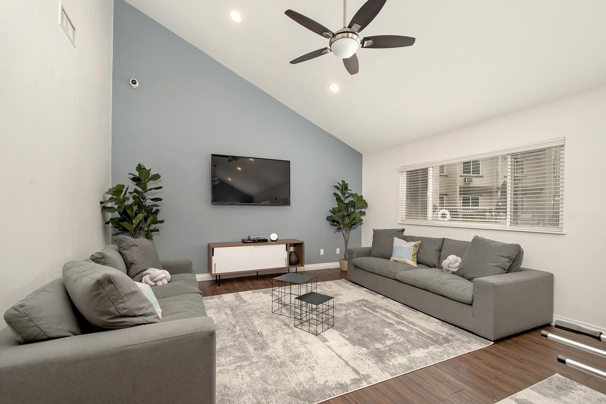 a living room filled with furniture and a large window