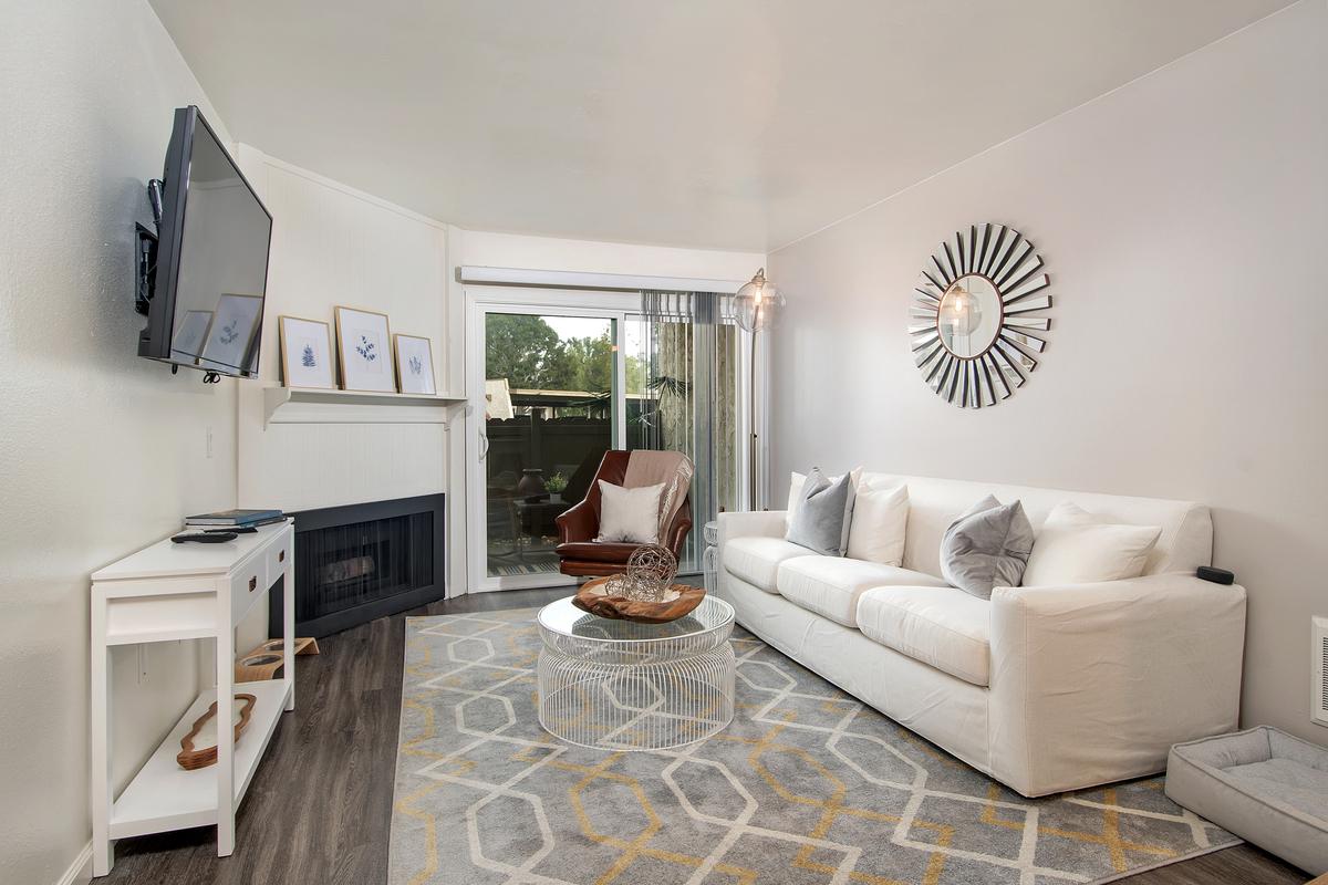 a living room filled with furniture and a large window