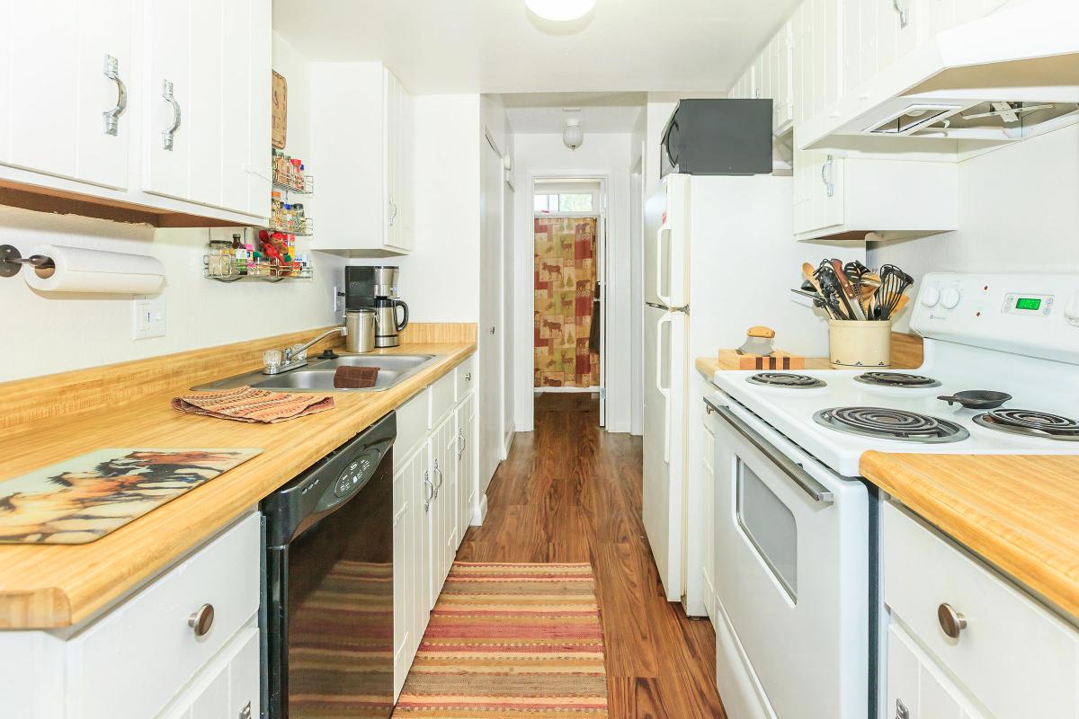 a kitchen with a stove top oven sitting next to a sink