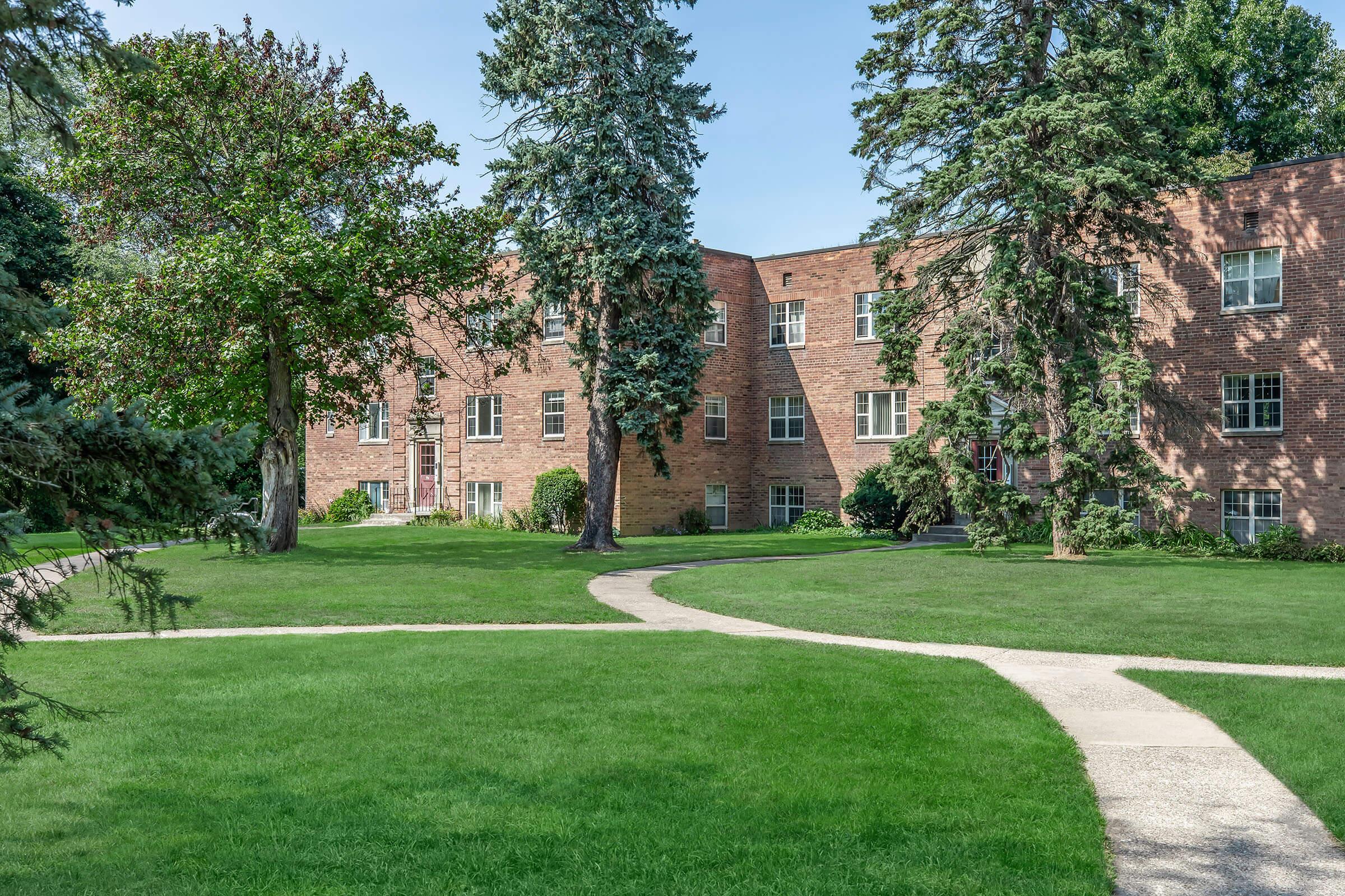 a large lawn in front of a brick building