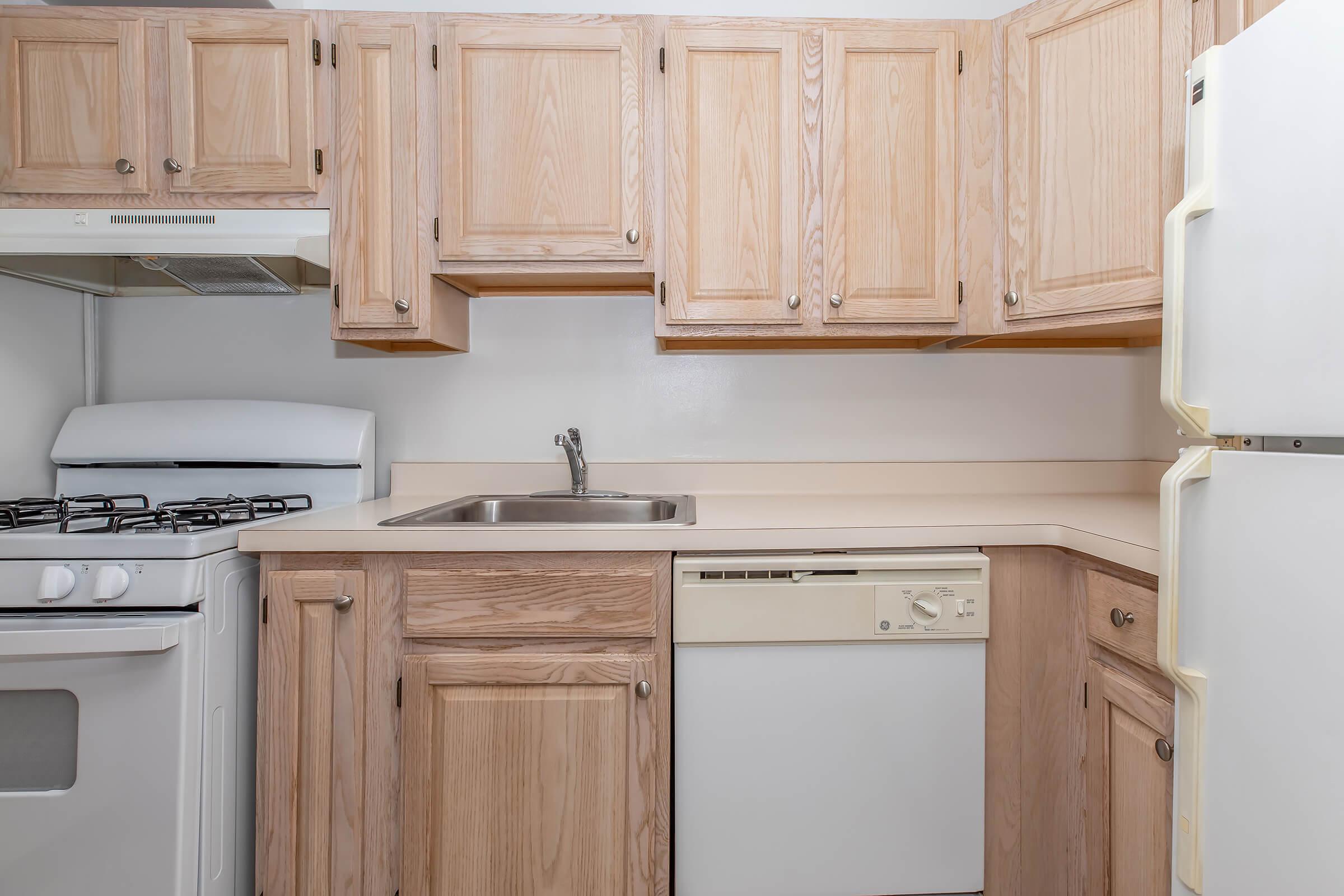 a kitchen with wooden cabinets and a microwave