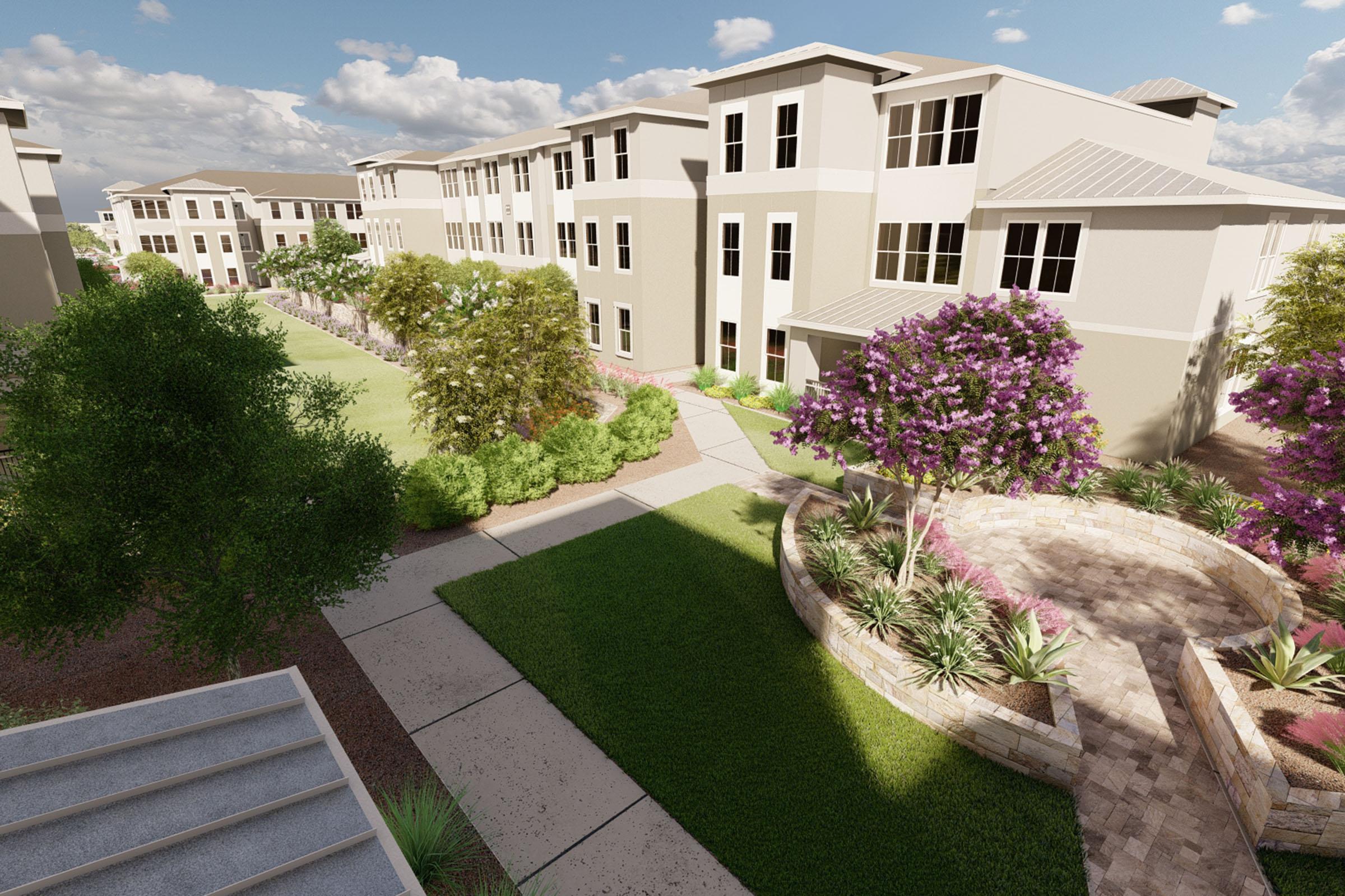 A modern residential complex featuring multi-story buildings surrounded by landscaped gardens, pathways, and outdoor seating areas. Lush greenery and flowering trees are visible, creating an inviting and serene environment under a partly cloudy sky.