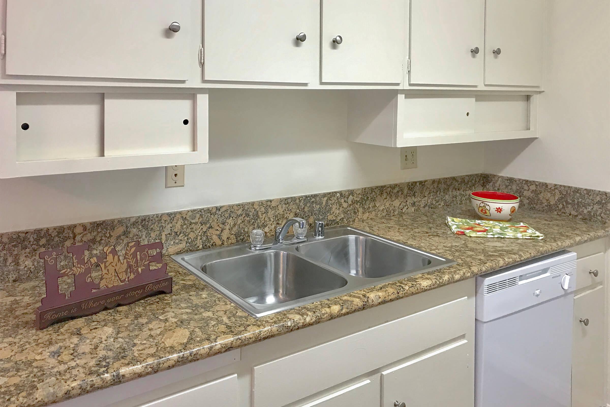 Kitchen sink with white cabinets