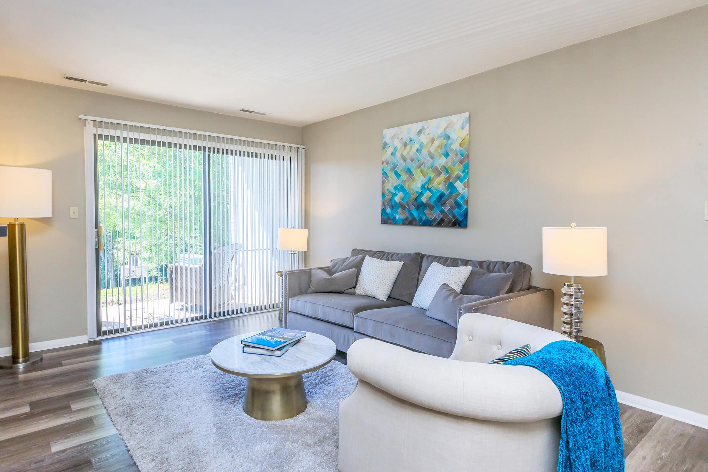 a living room filled with furniture and a large window