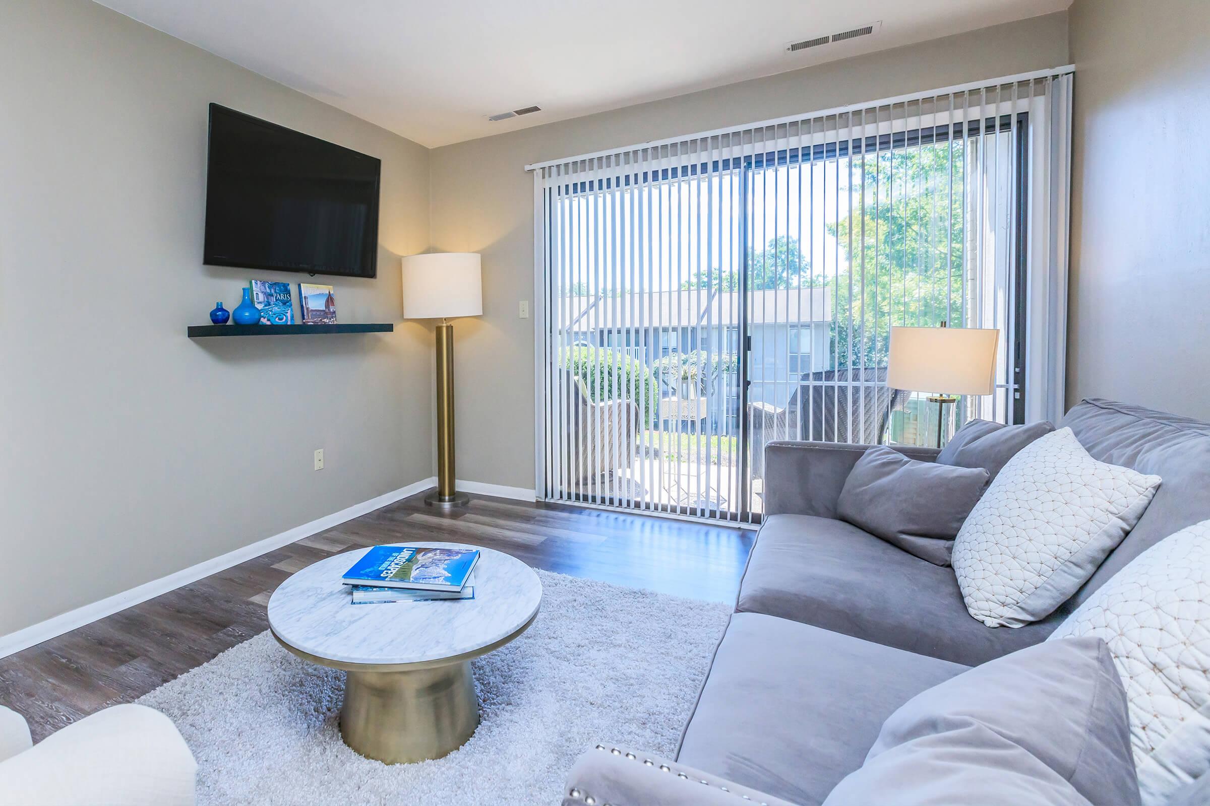 a living room filled with furniture and a large window